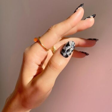 nails with a black and white tortoise shell design