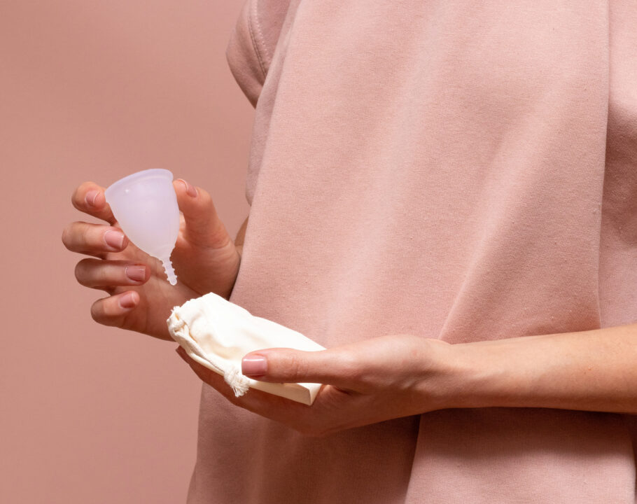 woman holding a menstrual cup