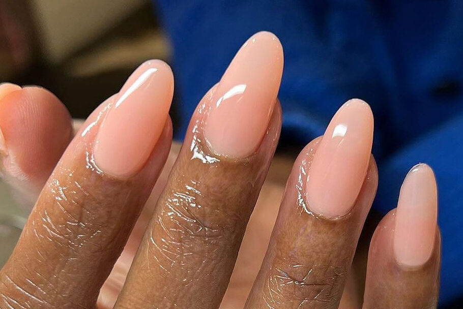 close-up of a manicure with oval-shaped nails and nude polish