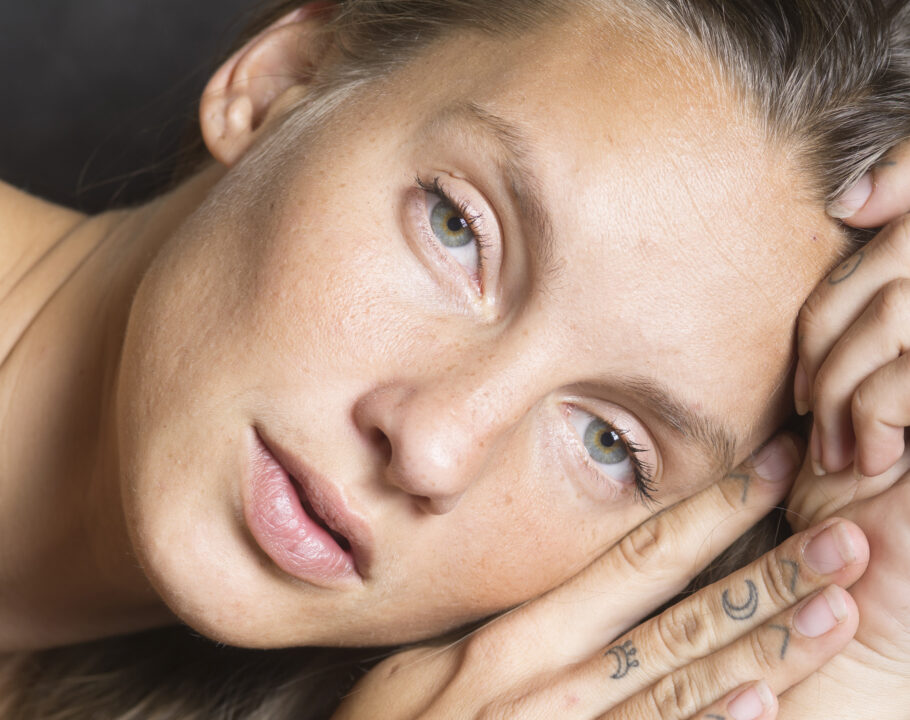 Bare-faced woman looking at camera